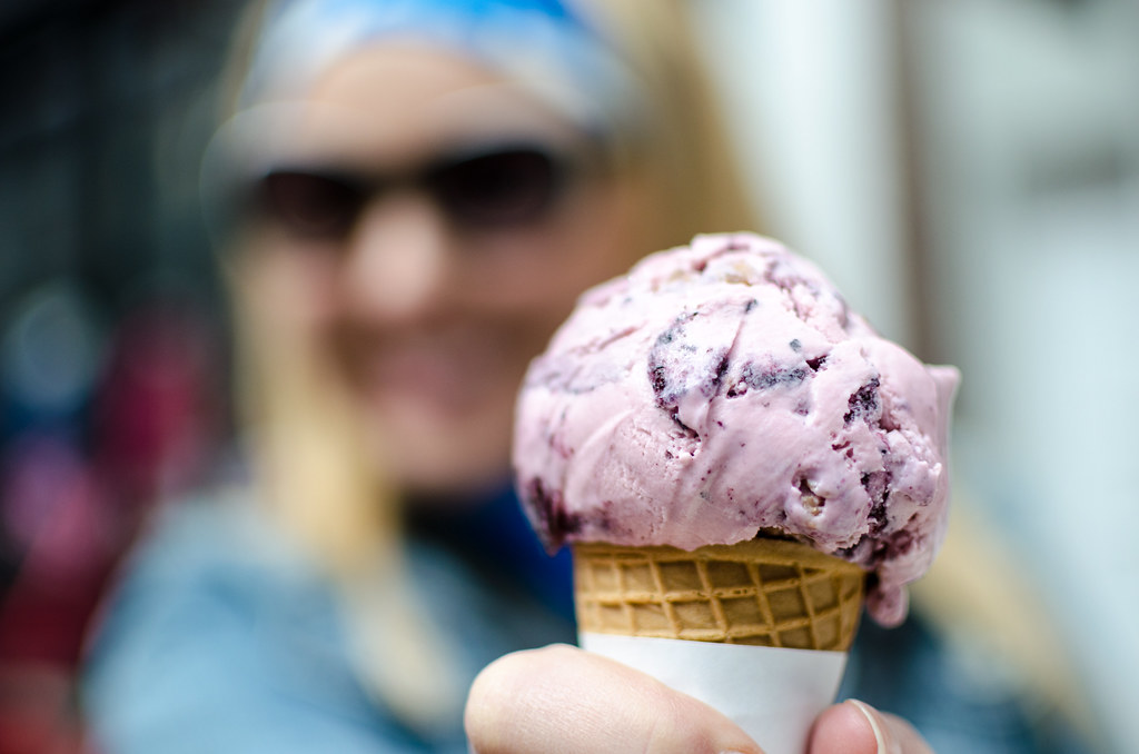 A photo of a person holding an ice cream cone. The photo was taken at the Navarre Ice Cream Shop in Navarre, Florida.